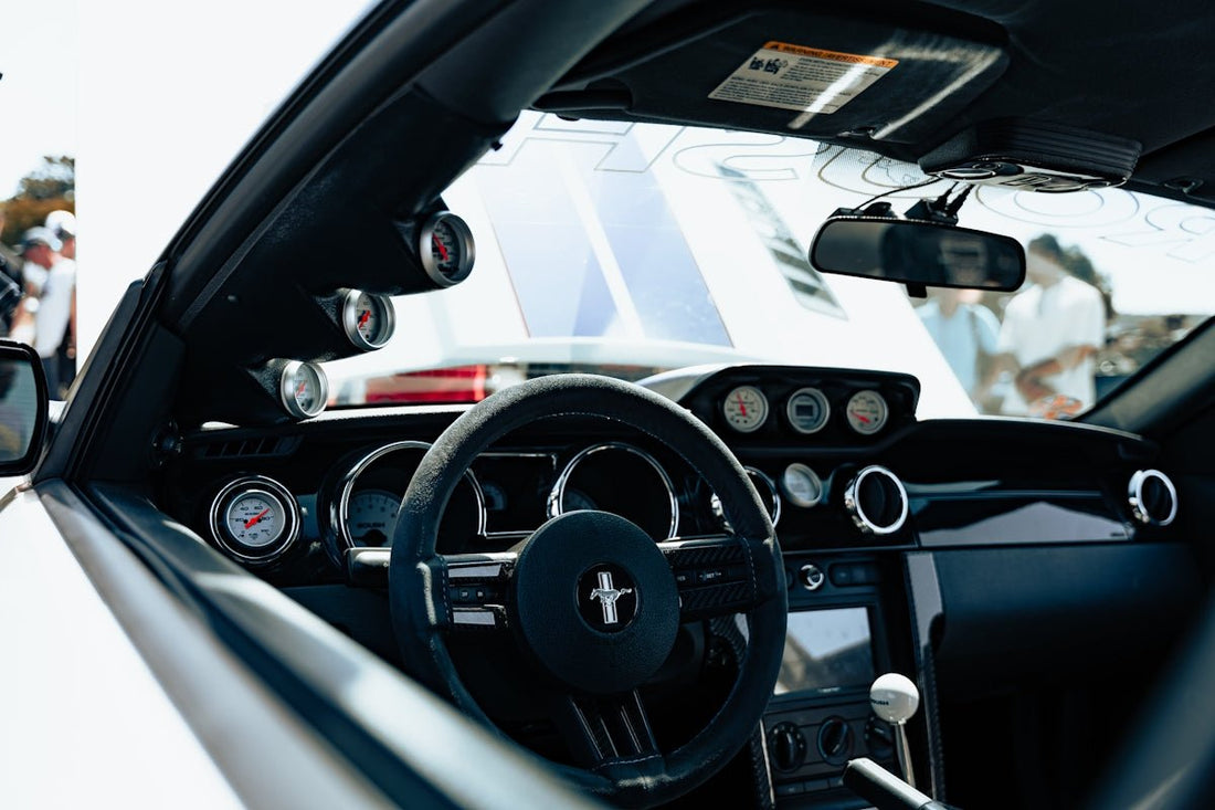 A close up of a steering wheel and dashboard of a car