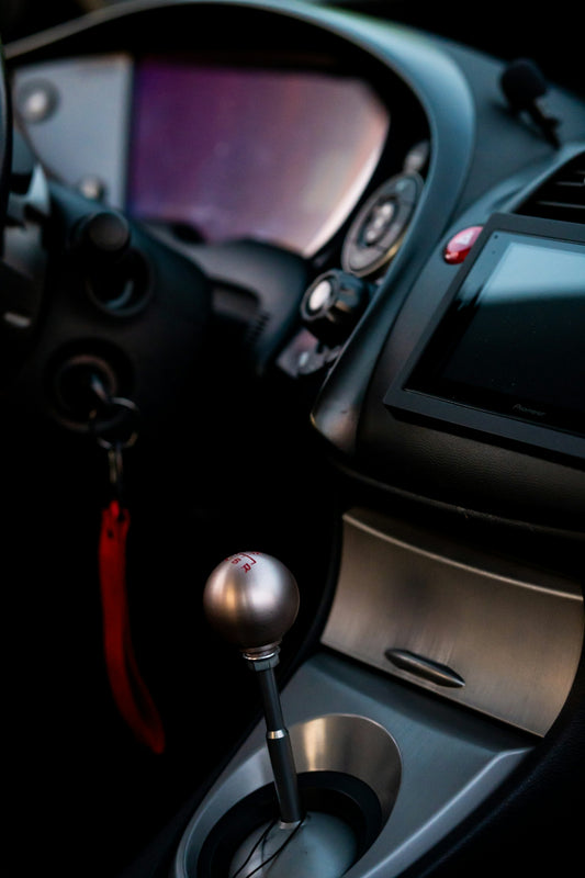 a close-up of a car's steering wheel and dashboard