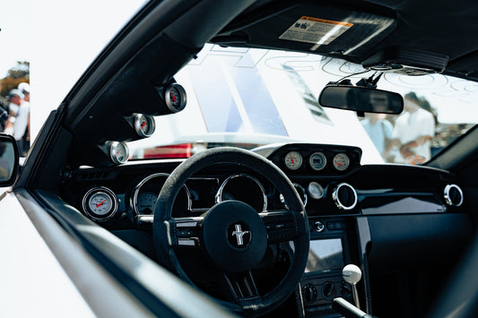A close up of a steering wheel and dashboard of a car