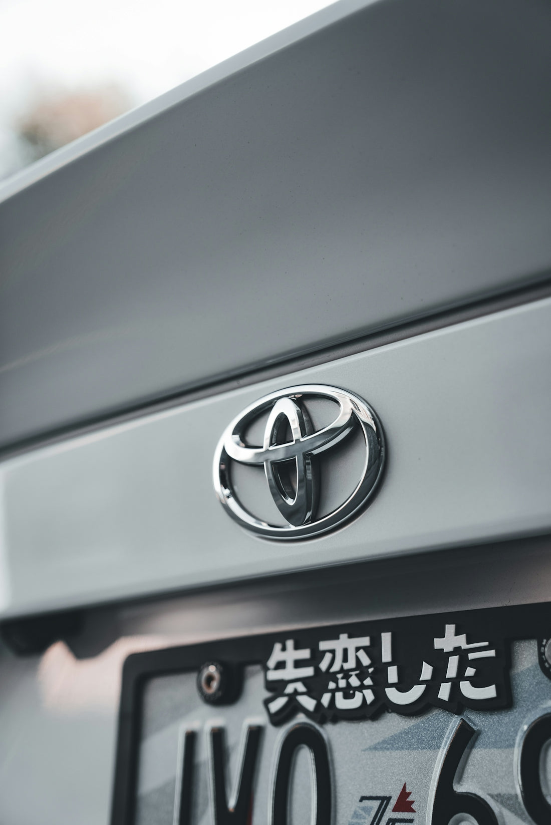 A close-up shows the toyota emblem on a car.
