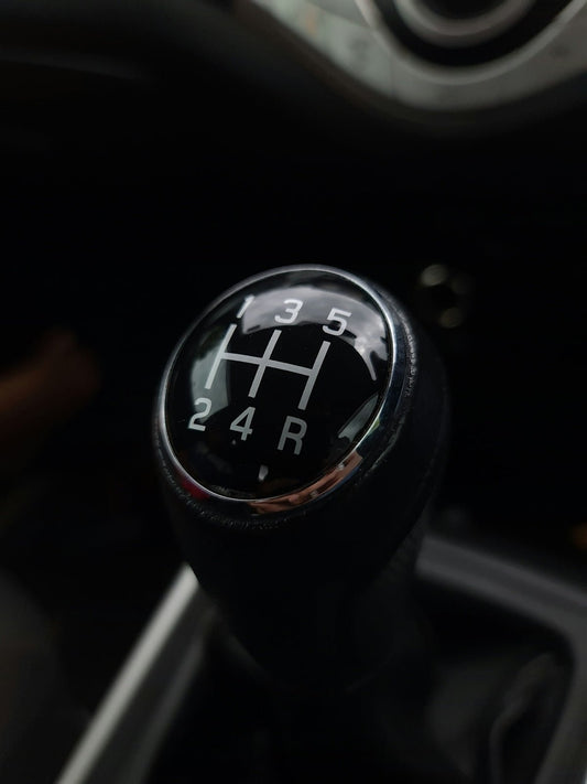 black and silver car gear shift lever